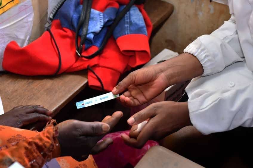 Close-up of a rapid HIV test being administered by a foundation health worker